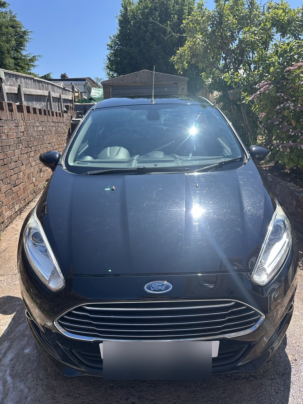 Black Ford Fiesta gleaming after a full exterior detail