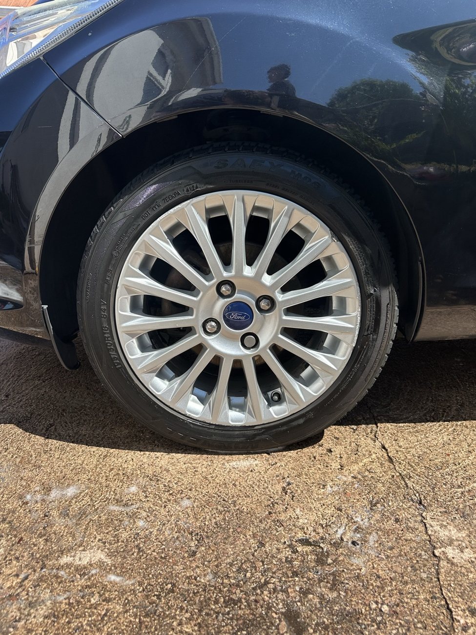 Glossy alloy wheel and freshly dressed tyre on the black Ford Fiesta
