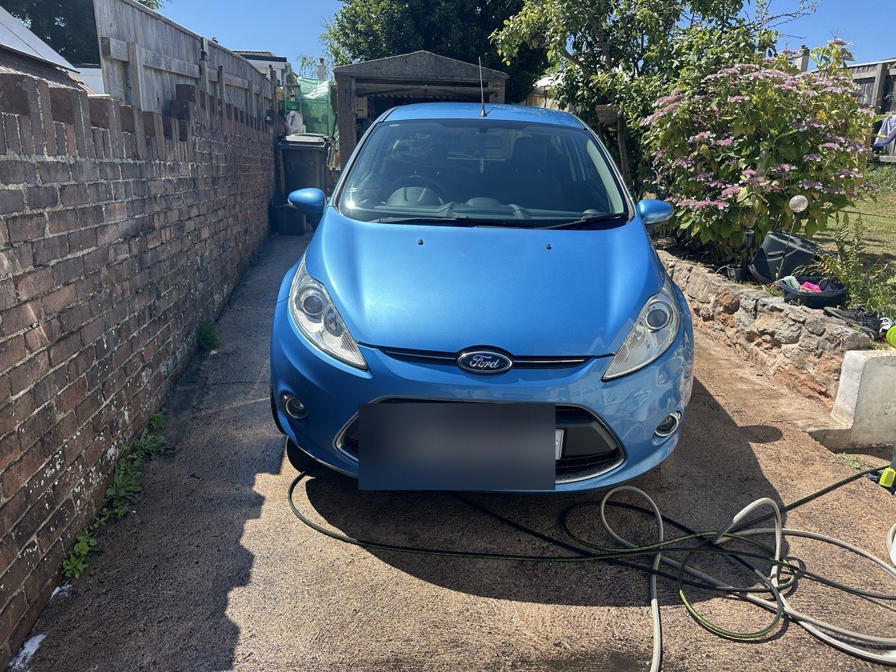 Blue Ford Fiesta gleaming after an exterior valet