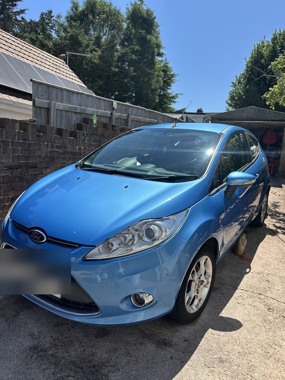 Blue Ford Fiesta front three-quarter after detailing