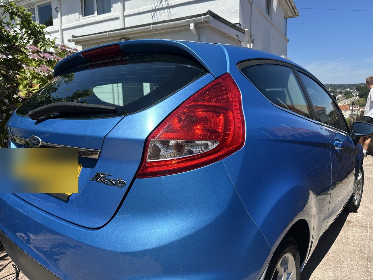 Blue Ford Fiesta rear three-quarter after detailing