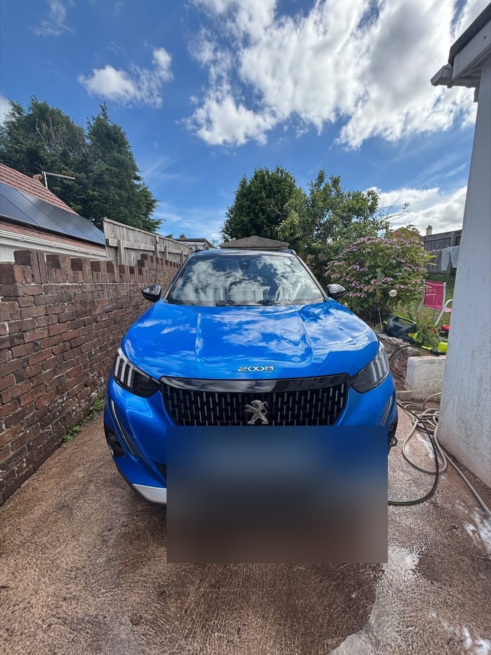 Blue Peugeot 2008 gleaming after a wash