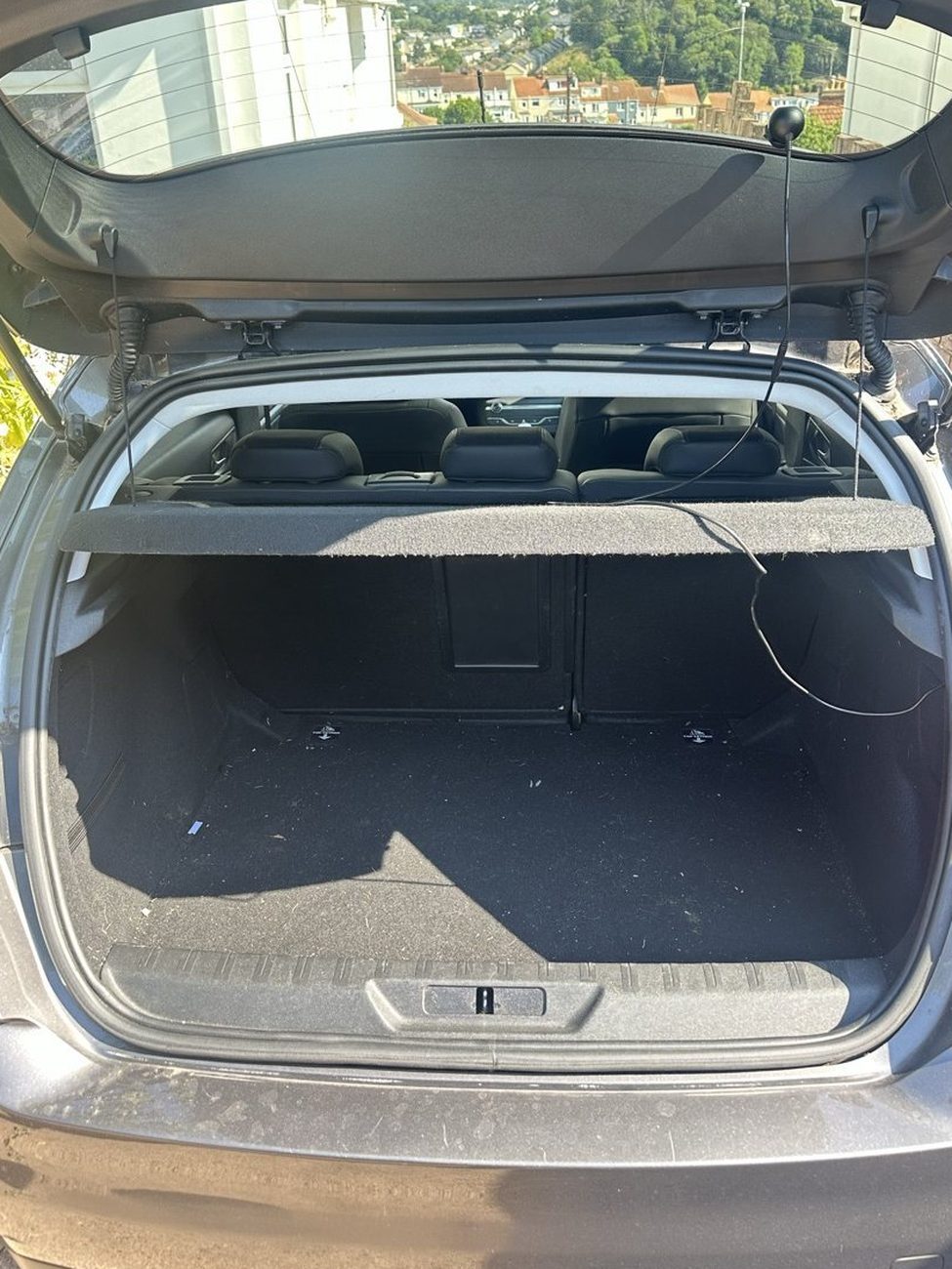 Peugeot 308 boot before, dusty carpet and debris