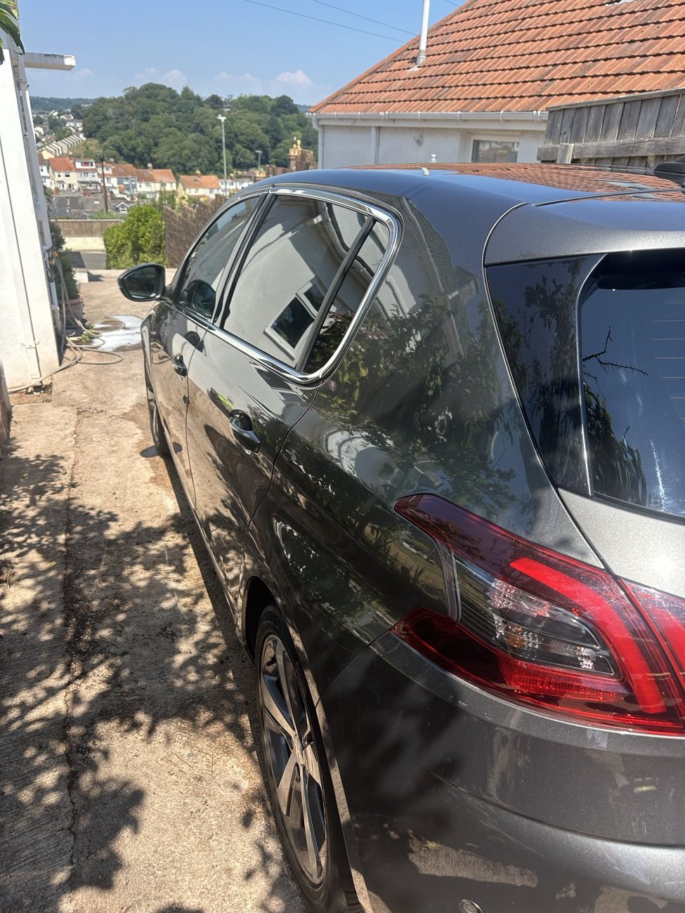 Grey Peugeot 308 rear three-quarter with a deep gloss finish